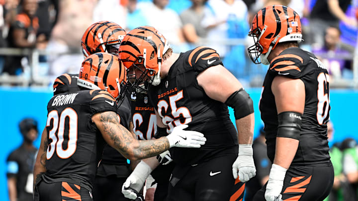 Sep 29, 2024; Charlotte, North Carolina, USA;  Cincinnati Bengals running back Chase Brown (30) celebrates with guard Alex Cappa (65) after scoring a touchdown in the first quarter at Bank of America Stadium. Mandatory Credit: Bob Donnan-Imagn Images