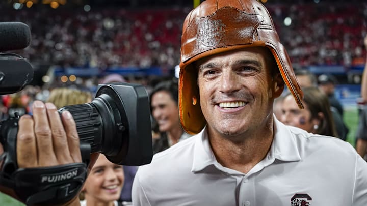 Aug 31, 2025; Atlanta, Georgia, USA; South Carolina Gamecocks head coach Shane Beamer wears the Old Leather Helmet after defeating the Virginia Tech Hokies at Mercedes-Benz Stadium. Mandatory Credit: Dale Zanine-Imagn Images