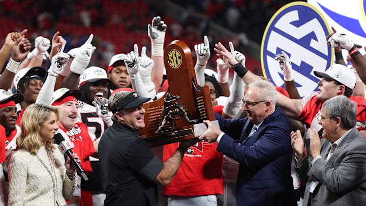 Dec 6, 2025; Atlanta, GA, USA; Georgia Bulldogs head coach Kirby Smart lifts the SEC Championship trophy after the game against the Alabama Crimson Tide during the 2025 SEC Championship game at Mercedes-Benz Stadium. Mandatory Credit: Brett Davis-Imagn Images