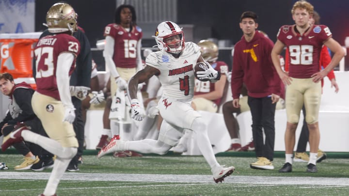 Louisville   s Maurice Turner runs for a first down against FSU   s Fentrell Cypress II in the AAC Football Championship game. 
Dec. 2, 2023