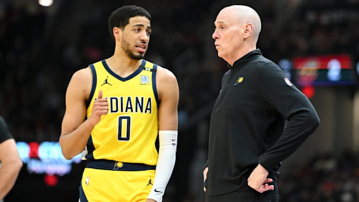 Indiana Pacers guard Tyrese Haliburton (0) and head coach Rick Carlisle during a game against the Cleveland Cavaliers.
