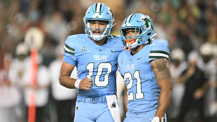 Tulane Green Wave players Darian Mensah (10) and Makhi Hughes (21) stand next to each other.