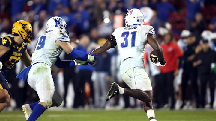 Dec 17, 2024; Frisco, TX, USA;  Memphis Tigers linebacker Elijah Herring (31) runs with the ball after making an interception at the end of the game against the West Virginia Mountaineers at Toyota Stadium. Mandatory Credit: Tim Heitman-Imagn Images