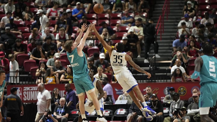 Jul 14, 2025; Las Vegas, NV, USA; Dallas Mavericks guard Matthew Cleveland (35) fouls Charlotte Hornets guard Kon Knueppel (7) during the first half of a NBA basketball game at the Thomas & Mack Center. Mandatory Credit: Lucas Peltier-Imagn Images