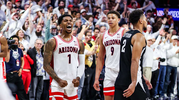 Arizona Wildcats guard Caleb Love (1) celebrates the win while Iowa State Cyclones forward Joshua Jefferson (2) leaves the court at the end of overtime at McKale Center. 