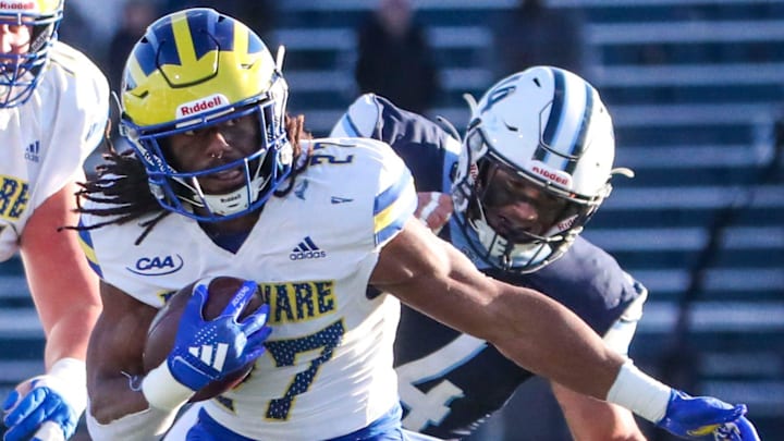 Delaware's Jo'Nathan Silver tries to elude Villanova's Richie Kimmel in the third quarter of the Blue Hens' 38-28 loss at Villanova Stadium, Saturday, Nov. 23, 2024.