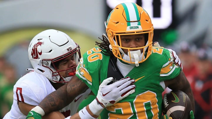 Oregon   s Jordan James, right, breaks into the open for a big gain against Washington State   s Sam Lockett III during the second quarter at Autzen Stadium Saturday, Oct. 21, 2023.