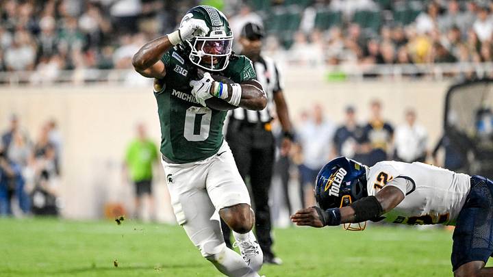 Michigan State’s Cam Edwards runs for a gain as Toledo’s Mo Conteh closes in during the first quarter on Friday, Sept. 4, 2026, at Spartan Stadium in East Lansing. Michigan State’s Cam Edwards runs for a gain as Toledo’s Mo Conteh closes in during the first quarter on Friday, Sept. 4, 2026, at Spartan Stadium in East Lansing.