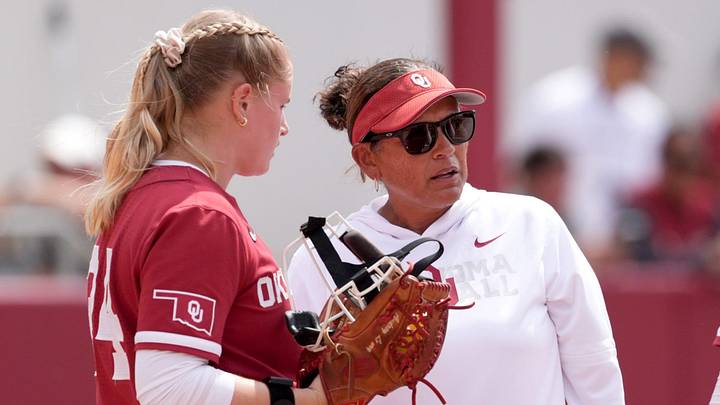 Oklahoma Associate Head Coach head Jennifer Rocha talks with Audrey Lowry (24) during the NCAA Norman Softball Regional game between the University of Oklahoma Sooners and Michigan Wolverines at Love's Field in Norman, Okla., May, 17, 2026. Oklahoma Associate Head Coach head Jennifer Rocha talks with Audrey Lowry (24) during the NCAA Norman Softball Regional game between the University of Oklahoma Sooners and Michigan Wolverines at Love's Field in Norman, Okla., May, 17, 2026.