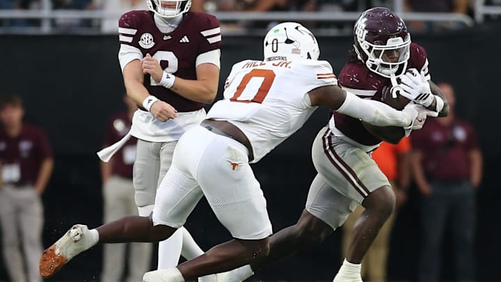 Oct 25, 2025; Starkville, Mississippi, USA; Mississippi State Bulldogs running back Davon Booth (6) runs the ball  as Texas Longhorns linebacker Anthony Hill Jr. (0) makes the tackle during the third quarter at Davis Wade Stadium at Scott Field. Mandatory Credit: Petre Thomas-Imagn Images