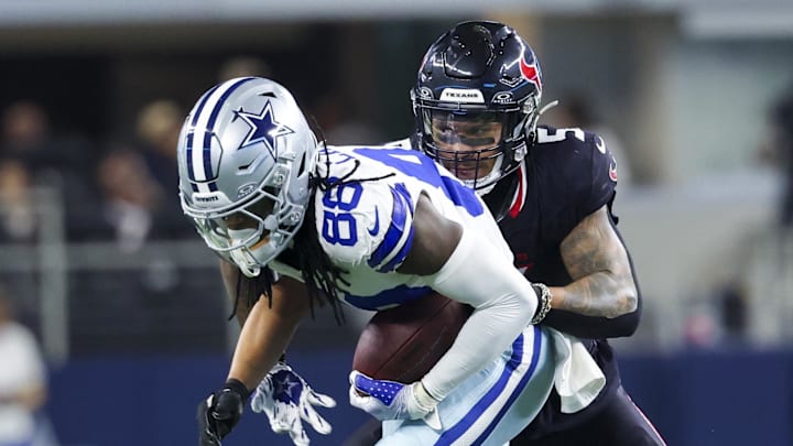 Nov 18, 2024; Arlington, Texas, USA;  Dallas Cowboys wide receiver CeeDee Lamb (88) runs with the ball as Houston Texans safety Jalen Pitre (5) defends during the first half at AT&T Stadium. Mandatory Credit: Kevin Jairaj-Imagn Images