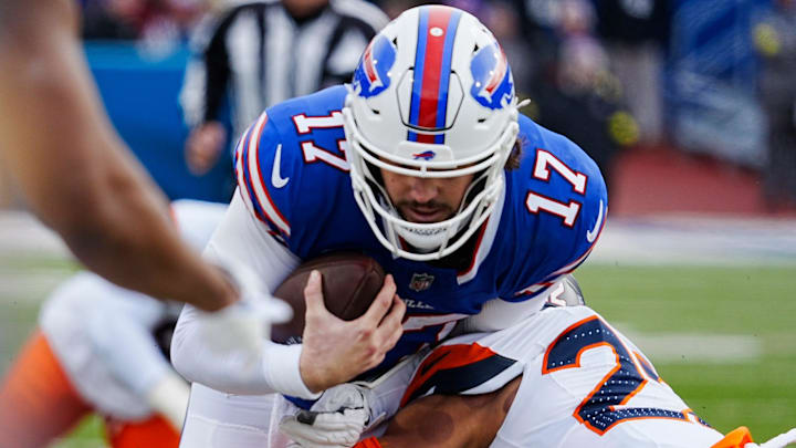 Buffalo Bills quarterback Josh Allen gets tackled by Denver Broncos safety Brandon Jones while carrying the ball during the first half of the Buffalo Bills wild card game against the Denver Broncos at Highmark Stadium in Orchard Park on Jan. 12, 2025. Buffalo Bills quarterback Josh Allen gets tackled by Denver Broncos safety Brandon Jones while carrying the ball during the first half of the Buffalo Bills wild card game against the Denver Broncos at Highmark Stadium in Orchard Park on Jan. 12, 2025.