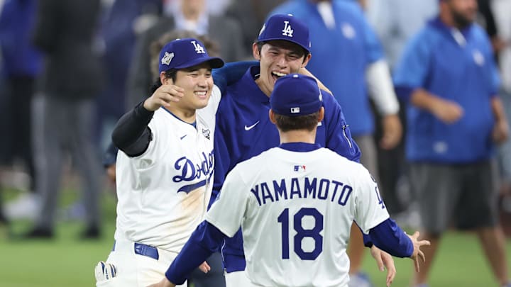 Oct 27, 2025; Los Angeles, California, USA; Los Angeles Dodgers designated hitter Shohei Ohtani (17) celebrates with pitcher Roki Sasaki (11) and pitcher Yoshinobu Yamamoto (18) after winning in the eighteenth inning against the Toronto Blue Jays in game three of the 2025 MLB World Series at Dodger Stadium. Mandatory Credit: Kiyoshi Mio-Imagn Images Oct 27, 2025; Los Angeles, California, USA; Los Angeles Dodgers designated hitter Shohei Ohtani (17) celebrates with pitcher Roki Sasaki (11) and pitcher Yoshinobu Yamamoto (18) after winning in the eighteenth inning against the Toronto Blue Jays in game three of the 2025 MLB World Series at Dodger Stadium. Mandatory Credit: Kiyoshi Mio-Imagn Images