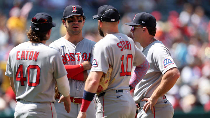 Jun 25, 2025; Anaheim, California, USA;  Boston Red Sox infielders (from left) Nate Eaton (40) and Romy Gonzalez (23) and Trevor Story (10) and Marcelo Mayer huddle during a pitching change in the fifth inning against the Los Angeles Angels at Angel Stadium. Mandatory Credit: Kiyoshi Mio-Imagn Images