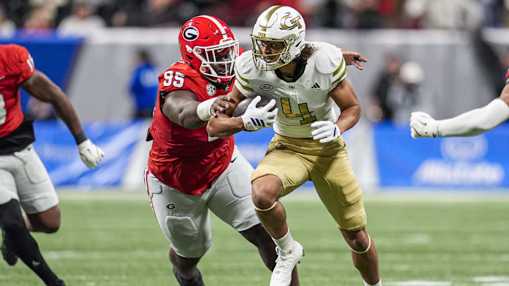 Nov 28, 2025; Atlanta, Georgia, USA; Georgia Tech Yellow Jackets wide receiver Isiah Canion (4) runs against Georgia Bulldogs defensive lineman Nnamdi Ogboko (95) during the second half at Mercedes-Benz Stadium. Mandatory Credit: Dale Zanine-Imagn Images Nov 28, 2025; Atlanta, Georgia, USA; Georgia Tech Yellow Jackets wide receiver Isiah Canion (4) runs against Georgia Bulldogs defensive lineman Nnamdi Ogboko (95) during the second half at Mercedes-Benz Stadium. Mandatory Credit: Dale Zanine-Imagn Images