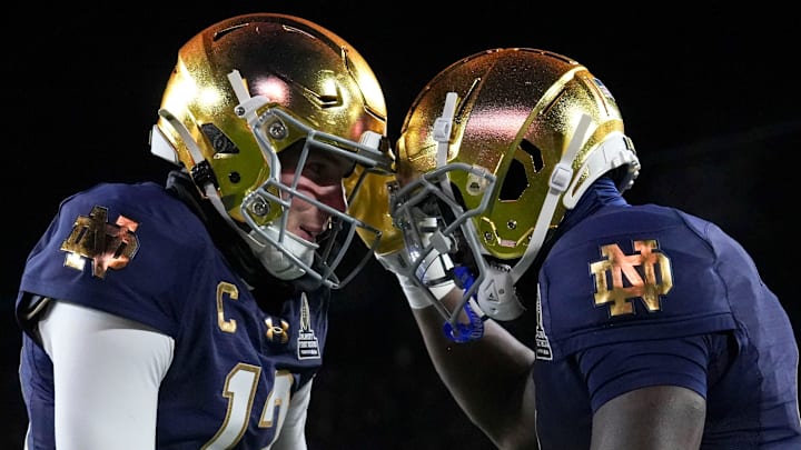 Notre Dame Fighting Irish quarterback Riley Leonard (13) and Notre Dame Fighting Irish running back Jeremiyah Love (4) celebrate a touchdown during the first half of a game between the Indiana Hoosiers and the Notre Dame Fighting Irish in first round of the College Football Playoff on Friday, Dec. 20, 2024, in South Bend. Notre Dame defeated Indiana 27-17.