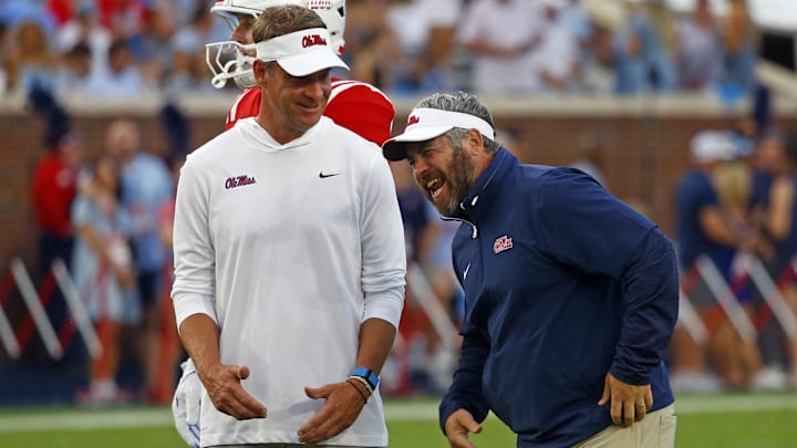 Sep 21, 2024; Oxford, Mississippi, USA; Mississippi Rebels head coach Lane Kiffin (left) shares a laugh with defensive coordinator Pete Golding (right) during warm ups prior to the game against the Georgia Southern Eagles at Vaught-Hemingway Stadium. Mandatory Credit: Petre Thomas-Imagn Images Sep 21, 2024; Oxford, Mississippi, USA; Mississippi Rebels head coach Lane Kiffin (left) shares a laugh with defensive coordinator Pete Golding (right) during warm ups prior to the game against the Georgia Southern Eagles at Vaught-Hemingway Stadium. Mandatory Credit: Petre Thomas-Imagn Images