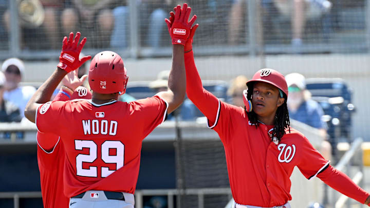 Mar 13, 2025; Port Charlotte, Florida, USA; Washington Nationals designated hitter James Woods (29) celebrates with shortstop CJ Abrams (5) and right fielder Dylan Crews (3) after hitting a three run home run in the first inning against the Tampa Bays Rays during spring training at Charlotte Sports Park.