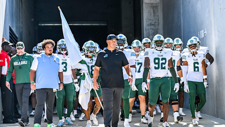 Tulane Green Wave football coach, Jon Sumrall, walks out of the tunnel with his team.