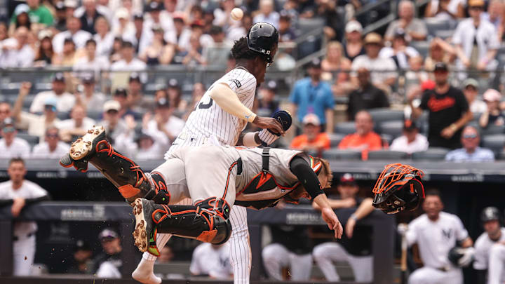 Bronx, New York, USA; New York Yankees second baseman Jazz Chisholm Jr. (13) collides with Baltimore Orioles catcher Maverick Handley (98) at home plate during the second inning at Yankee Stadium.