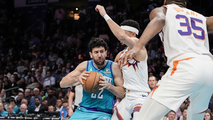 Mar 15, 2024; Charlotte, North Carolina, USA; Charlotte Hornets guard Vasa Micic (22) runs into Phoenix Suns guard Bradley Beal (3) during the second half at Spectrum Center. Mandatory Credit: Jim Dedmon-Imagn Images