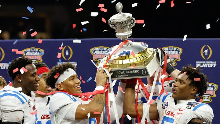 Mississippi Rebels quarterback Trinidad Chambliss (6) and running back Kewan Lacy (5) lift the trophy after the 2026 Sugar Bowl and quarterfinal game of the College Football Playoff against the Georgia Bulldogs at Caesars Superdome. Mandatory Credit: Amber Searls-Imagn Images Mississippi Rebels quarterback Trinidad Chambliss (6) and running back Kewan Lacy (5) lift the trophy after the 2026 Sugar Bowl and quarterfinal game of the College Football Playoff against the Georgia Bulldogs at Caesars Superdome. Mandatory Credit: Amber Searls-Imagn Images