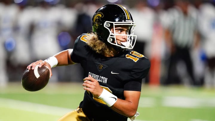 Oct 20, 2023; Carrollton, GA, USA; Carrollton Trojans quarterback Julian Lewis (10) scrambles out of the pocket against the Westlake Lions during the first half at Grisham Stadium. The 15-year-old Carrollton High student has already committed to playing for the University of Southern California Trojans and has been considered one of the top high school quarterback prospects. Mandatory Credit: John David Mercer-USA TODAY Sports