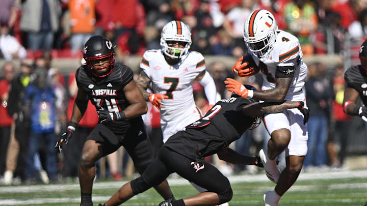 Oct 19, 2024; Louisville, Kentucky, USA; Miami Hurricanes running back Mark Fletcher Jr. (4) runs the ball against Louisville Cardinals defensive back Tamarion McDonald (12) during the first half at L&N Federal Credit Union Stadium. Miami defeated Louisville 52-45. Mandatory Credit: Jamie Rhodes-Imagn Images Oct 19, 2024; Louisville, Kentucky, USA; Miami Hurricanes running back Mark Fletcher Jr. (4) runs the ball against Louisville Cardinals defensive back Tamarion McDonald (12) during the first half at L&N Federal Credit Union Stadium. Miami defeated Louisville 52-45. Mandatory Credit: Jamie Rhodes-Imagn Images