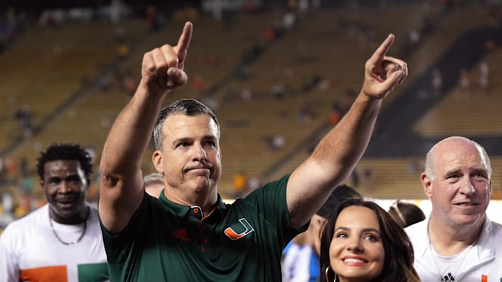 Oct 5, 2024; Berkeley, California, USA; Miami Hurricanes head coach Mario Cristobal (center left) gestures to fans with wife Jessica (center right) after defeating the California Golden Bears at California Memorial Stadium. Mandatory Credit: Darren Yamashita-Imagn Images Oct 5, 2024; Berkeley, California, USA; Miami Hurricanes head coach Mario Cristobal (center left) gestures to fans with wife Jessica (center right) after defeating the California Golden Bears at California Memorial Stadium. Mandatory Credit: Darren Yamashita-Imagn Images