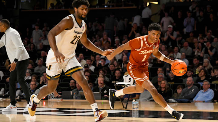 Feb 8, 2025; Nashville, Tennessee, USA; Texas Longhorns guard Julian Larry (1) dribbles past Vanderbilt Commodores forward Jaylen Carey (22) during the second half at Memorial Gymnasium. Mandatory Credit: Steve Roberts-Imagn Images Feb 8, 2025; Nashville, Tennessee, USA; Texas Longhorns guard Julian Larry (1) dribbles past Vanderbilt Commodores forward Jaylen Carey (22) during the second half at Memorial Gymnasium. Mandatory Credit: Steve Roberts-Imagn Images
