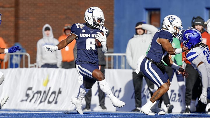 Dec 23, 2023; Boise, ID, USA; Utah State Aggies running back Davon Booth (6) runs for a touchdown during the first half against the Georgia State Panthers at Albertsons Stadium.  Mandatory Credit: Brian Losness-USA TODAY Sports

