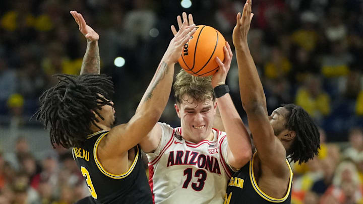 Apr 4, 2026; Indianapolis, IN, USA;  Arizona Wildcats center Motiejus Krivas (13) battles for the ball in between Michigan Wolverines forward Morez Johnson Jr. (21) and Michigan Wolverines guard Elliot Cadeau (3) in the first half during a semifinal of the Final Four of the men's 2026 NCAA Tournament at Lucas Oil Stadium. Mandatory Credit: Robert Deutsch-Imagn Images
