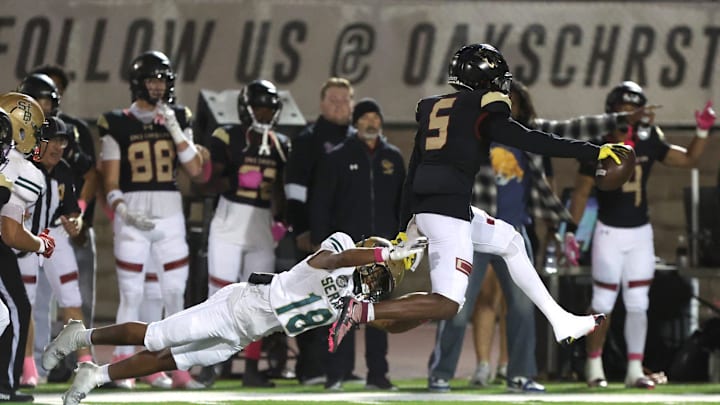 Oaks Christian's Davon Benjamin leaps free from St. Bonaventure's Darrien Johnson return an interception for a touchdown in the third quarter of Oaks Christian's win over visiting St. Bonaventure Friday at Redell Field. The Lions won, 35-0.