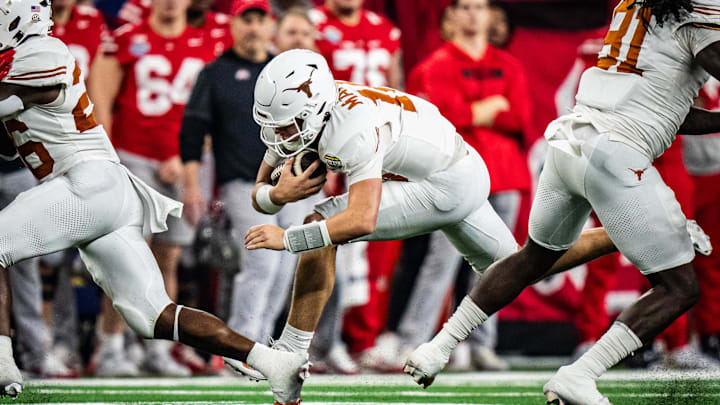 Texas Longhorns quarterback Manning carries the ball for a first down in the second quarter as the Texas Longhorns play the Ohio State Buckeyes in the Cotton Bowl College Football Playoff semi-final at AT&T Stadium