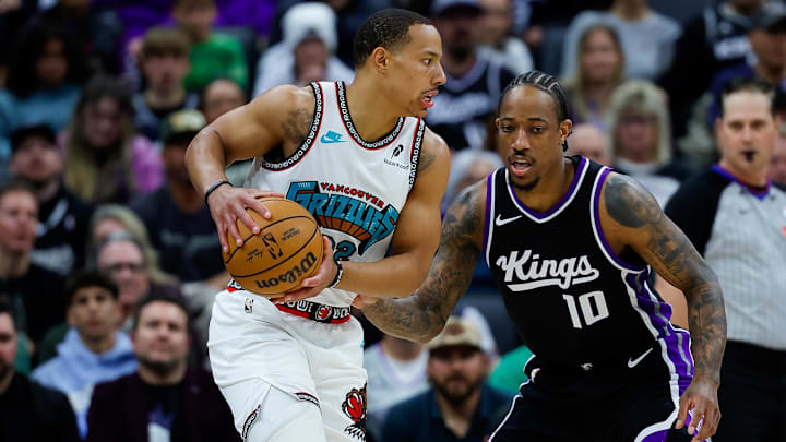 Mar 17, 2025; Sacramento, California, USA; Memphis Grizzlies guard Desmond Bane (22) controls the ball against Sacramento Kings forward DeMar DeRozan (10) during the first quarter at Golden 1 Center. Mandatory Credit: Sergio Estrada-Imagn Images