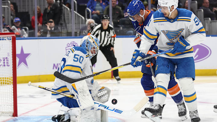Nov 22, 2025; Elmont, New York, USA; St. Louis Blues goaltender Jordan Binnington (50) defends the net as left wing Anders Lee (27) and St. Louis Blues defenseman Matthew Kessel (51) battle for control of the puck in the second period at UBS Arena. Mandatory Credit: Wendell Cruz-Imagn Images Nov 22, 2025; Elmont, New York, USA; St. Louis Blues goaltender Jordan Binnington (50) defends the net as left wing Anders Lee (27) and St. Louis Blues defenseman Matthew Kessel (51) battle for control of the puck in the second period at UBS Arena. Mandatory Credit: Wendell Cruz-Imagn Images
