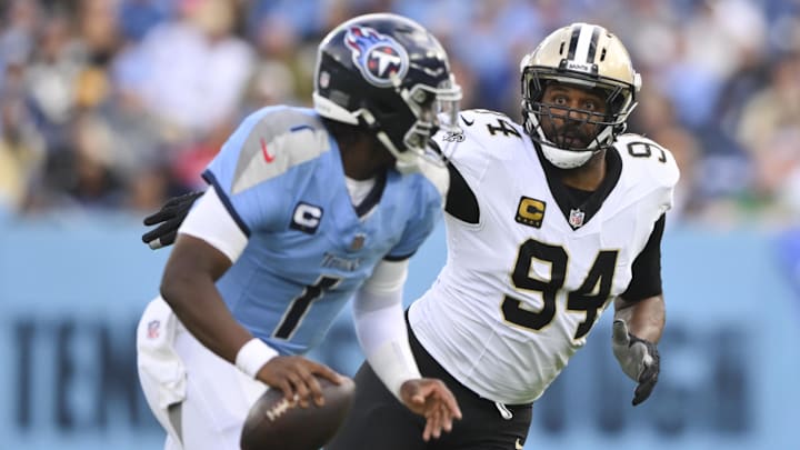 Dec 28, 2025; Nashville, Tennessee, USA;  New Orleans Saints defensive end Cameron Jordan (94) gives chase to Tennessee Titans quarterback Cam Ward (1) during the second half of the game at Nissan Stadium. Mandatory Credit: Steve Roberts-Imagn Images