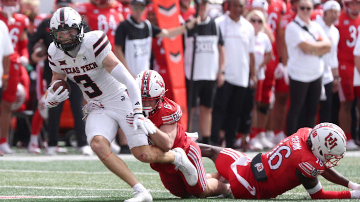 Sep 20, 2025; Salt Lake City, Utah, USA; Texas Tech Red Raiders wide receiver Coy Eakin (3) runs after a catch against Utah Utes cornerback Elijah Davis (9) and cornerback Blake Cotton (16) during the fourth quarter at Rice-Eccles Stadium. Mandatory Credit: Rob Gray-Imagn Images