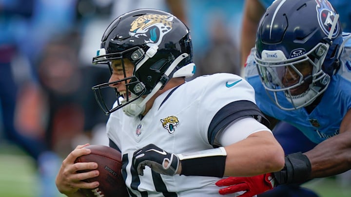 Tennessee Titans linebacker Otis Reese IV (41) tackles Jacksonville Jaguars quarterback Mac Jones (10) during the first quarter at Nissan Stadium in Nashville, Tenn., Sunday, Dec. 8, 2024.