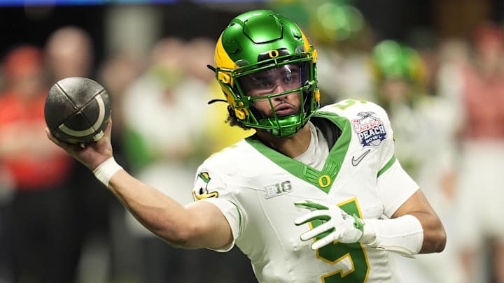 Oregon Ducks quarterback Dante Moore (5) throws a pass during the fourth quarter the 2025 Peach Bowl and semifinal game of the College Football Playoff at Mercedes-Benz Stadium. 