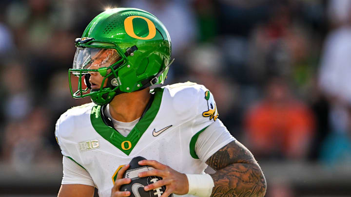 Oregon Ducks quarterback Dillon Gabriel (8) looks for an opening during the second half of the annual rivalry game against the Oregon State Beavers on Saturday, Sept. 14, 2024 at Reser Stadium in Corvallis, Ore.