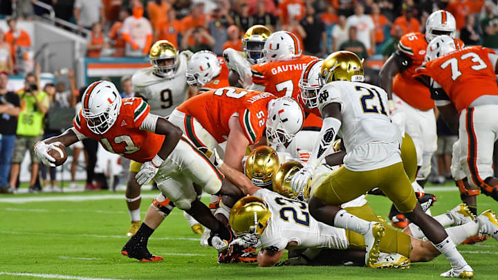 Nov 11, 2017; Miami Gardens, FL, USA; Miami Hurricanes quarterback DeeJay Dallas (13) dives into the end zone to score a touchdown against the Notre Dame Fighting Irish during the second half at Hard Rock Stadium. Mandatory Credit: Jasen Vinlove-Imagn Images