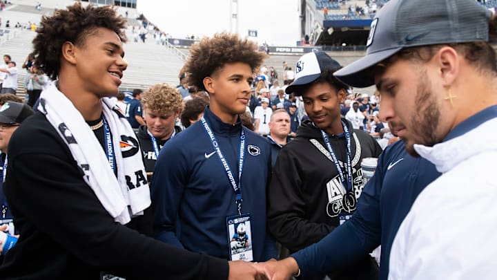 Penn State recruits, including class of 2026 Florida players Jyron Hughley (left) and Dia Bell (center), on the sideline following the Nittany Lions' 33-24 win over Indiana at Beaver Stadium Saturday, Oct. 28, 2023, in State College, Pa.