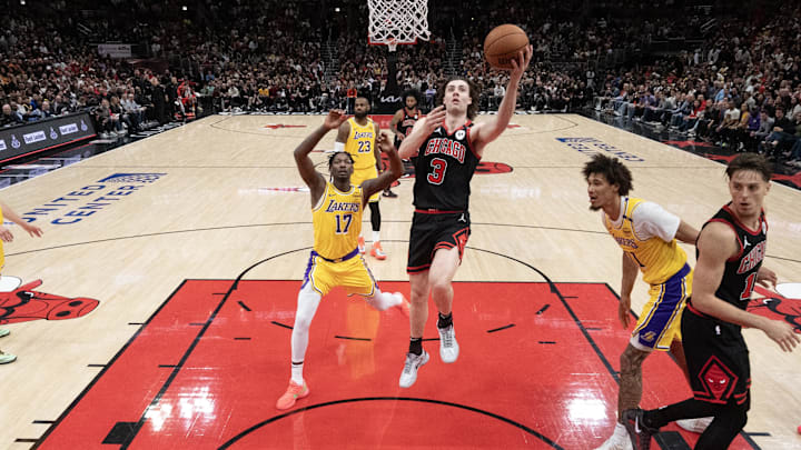 Mar 27, 2025; Chicago, Illinois, USA; Los Angeles Lakers forward Dorian Finney-Smith (17) defends Chicago Bulls guard Josh Giddey (3) during the second half at United Center. Mandatory Credit: David Banks-Imagn Images