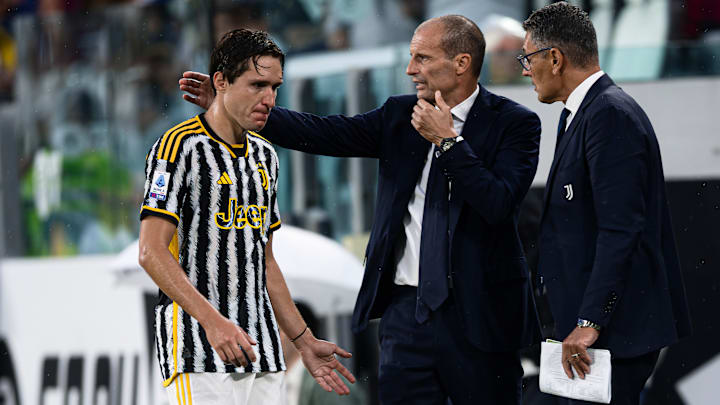 Federico Chiesa (L) of Juventus FC receives a pat on the...