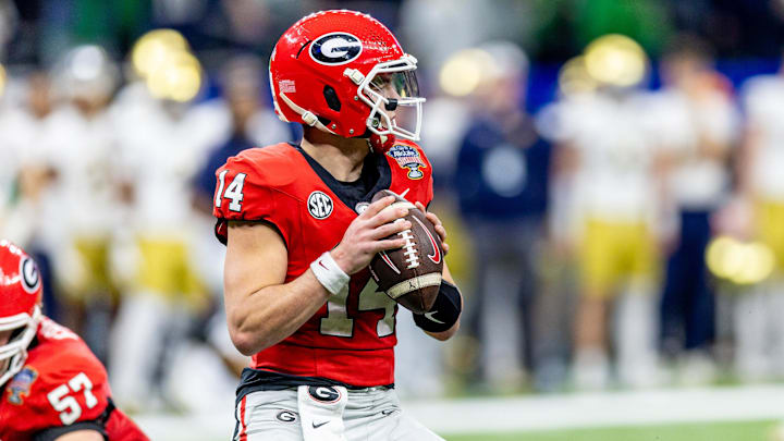 Jan 2, 2025; New Orleans, LA, USA;  Georgia Bulldogs quarterback Gunner Stockton (14) drops back to pass against the Notre Dame Fighting Irish during the first half at Caesars Superdome. Mandatory Credit: Stephen Lew-Imagn Images