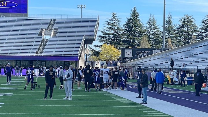 Players, coaches and trainers gather around an injured Jordan Washington. Players, coaches and trainers gather around an injured Jordan Washington.
