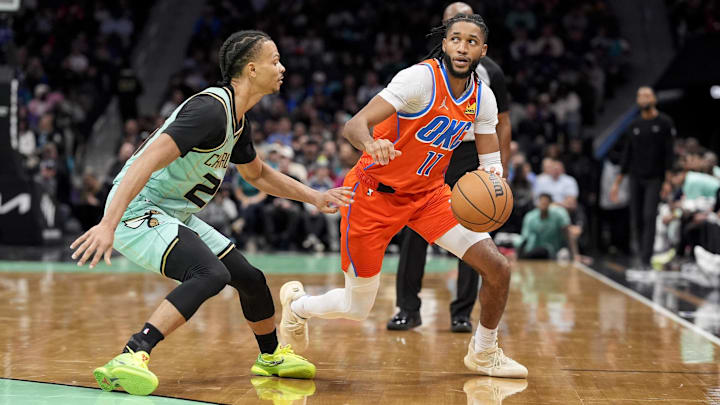 Dec 28, 2024; Charlotte, North Carolina, USA; Oklahoma City Thunder guard Isaiah Joe (11) looks to pass defended by Charlotte Hornets guard Isaiah Wong (21) during the second half at Spectrum Center. Mandatory Credit: Jim Dedmon-Imagn Images Dec 28, 2024; Charlotte, North Carolina, USA; Oklahoma City Thunder guard Isaiah Joe (11) looks to pass defended by Charlotte Hornets guard Isaiah Wong (21) during the second half at Spectrum Center. Mandatory Credit: Jim Dedmon-Imagn Images