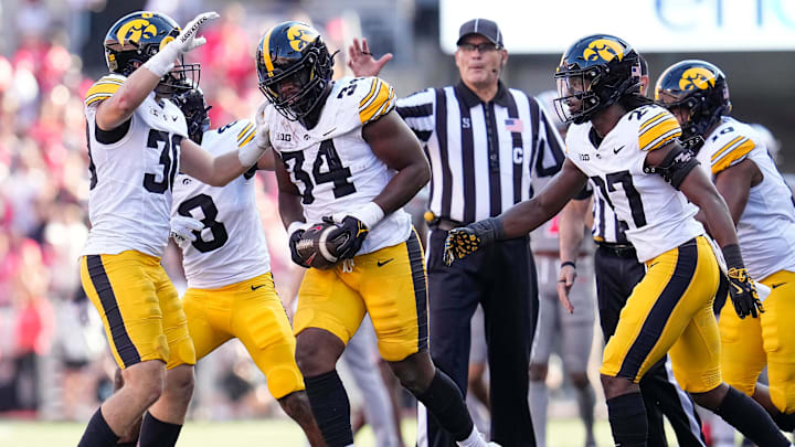 Oct 5, 2024; Columbus, OH, USA; Iowa Hawkeyes linebacker Jay Higgins (34) celebrates a fumble recovery after forcing Ohio State Buckeyes wide receiver Jeremiah Smith to lose the ball during the first half of the NCAA football game at Ohio Stadium.