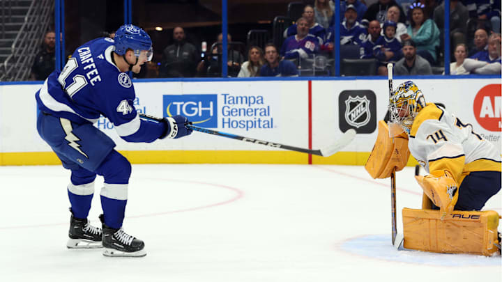 Oct 28, 2024; Tampa, Florida, USA; Tampa Bay Lightning right wing Mitchell Chaffee (41) shoots and scores on Nashville Predators goaltender Juuse Saros (74) during the first period at Amalie Arena. Mandatory Credit: Kim Klement Neitzel-Imagn Images